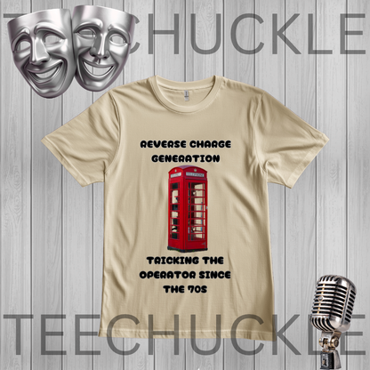 A sand graphic t-shirt featuring a red telephone booth illustration and the text 'REVERSE CHARGE GENERATION' and 'TRICKING THE OPERATOR SINCE THE 70s'. The t-shirt is displayed on a gray wood-plank background with silver comedy masks and a vintage microphone