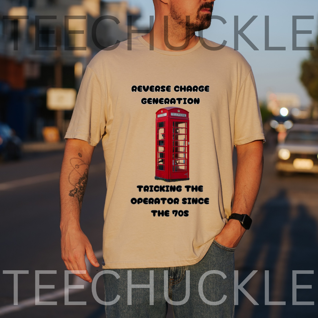 A man wearing a sand graphic t-shirt with a red telephone booth and the text 'REVERSE CHARGE GENERATION TRICKING THE OPERATOR SINCE THE 1970s' on a blurred street background. 