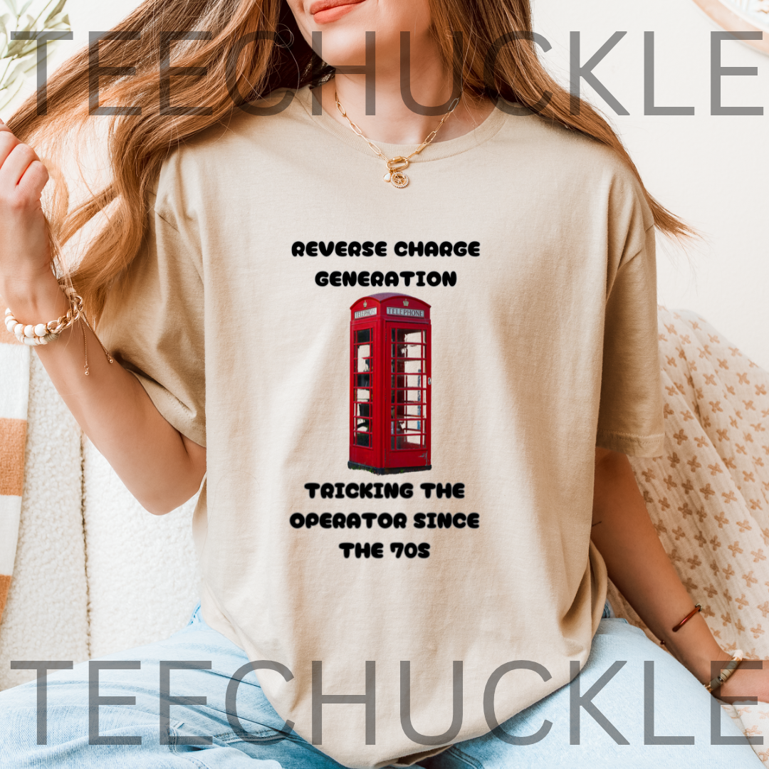 A woman wearing a sand graphic t-shirt with a red telephone booth print and the text 'REVERSE CHARGE GENERATION TRICKING THE OPERATOR SINCE THE 70s'.