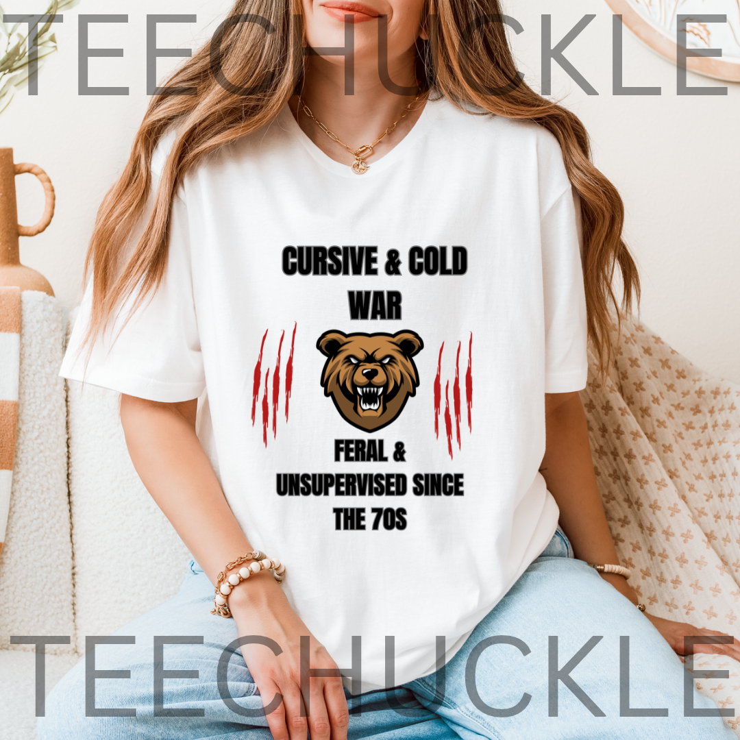 A woman wearing a white graphic t-shirt with a bear face and the text 'CURSIVE & COLD WAR FERAL & UNSUPERVISED SINCE THE 70S' flanked by red claw marks. 