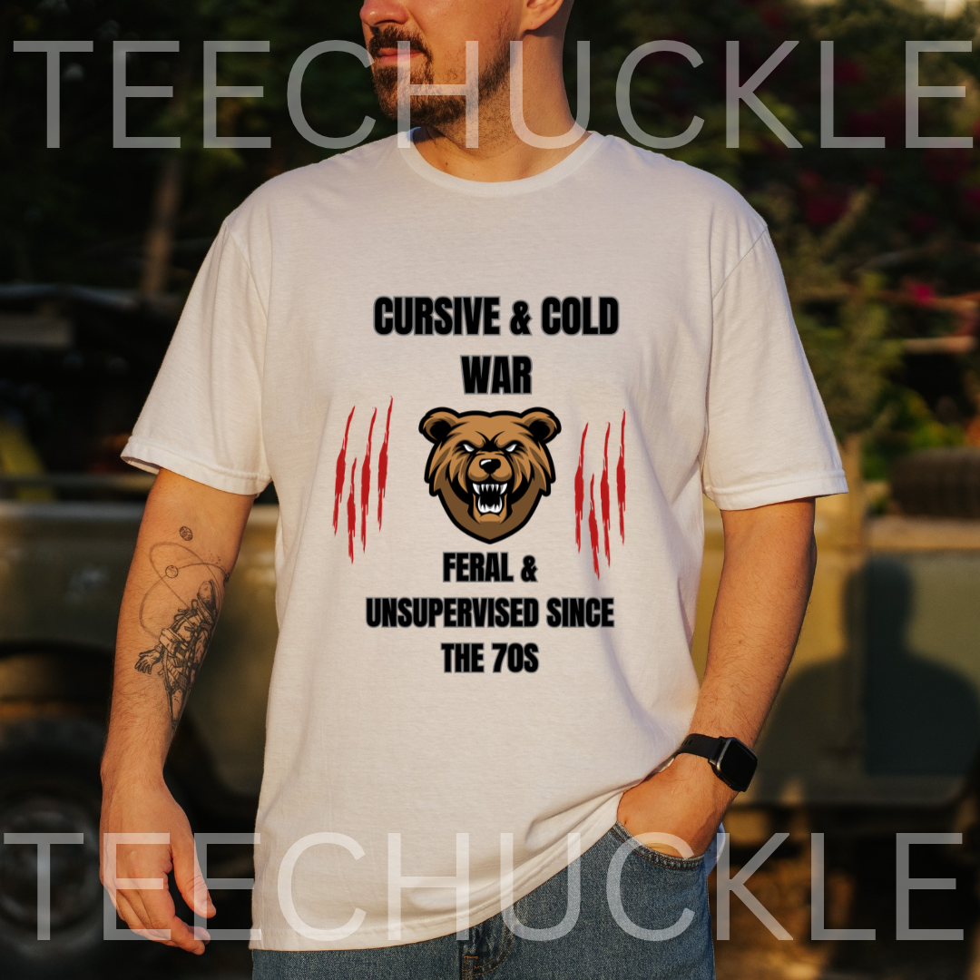A man wearing a white graphic t-shirt with a bear design and the text 'CURSIVE & COLD WAR FERAL & UNSUPERVISED SINCE THE 70S'. 