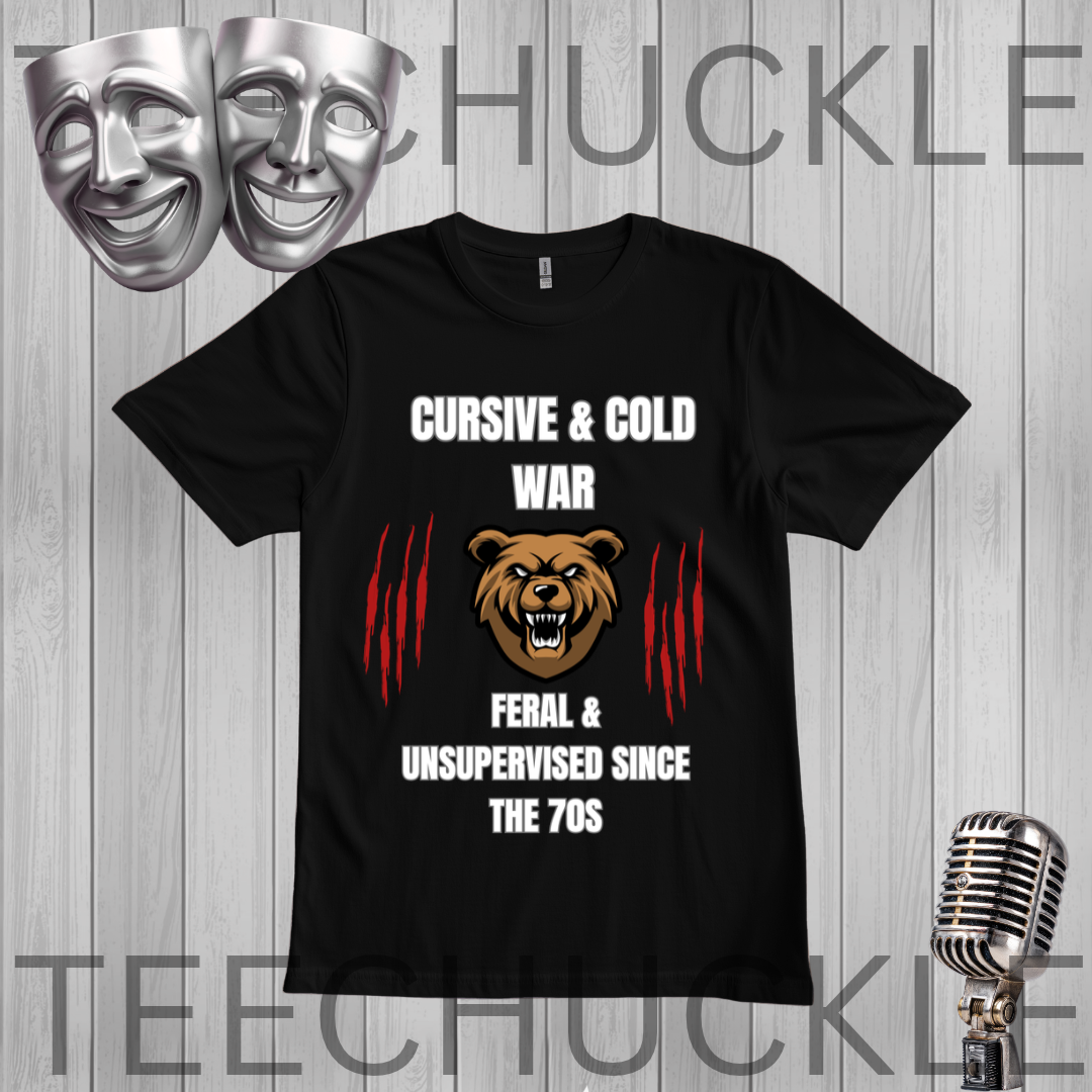 A black short-sleeve graphic t-shirt displayed on a gray wood-plank background. The shirt features a design with the text 'CURSIVE & COLD WAR' and 'FERAL & UNSUPERVISED SINCE THE 70S' in white, flanking a brown bear head graphic and red claw marks.