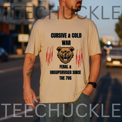 A man wearing a graphic t-shirt with a bear design and the text 'CURSIVE & COLD WAR FERAL & UNSUPERVISED SINCE THE 70S' in black and red, set against a blurred street background.