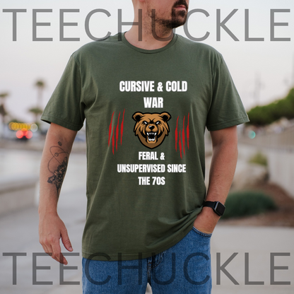 A man wearing a green graphic t-shirt with a bear design and text reading 'CURSIVE & COLD WAR FERAL & UNSUPERVISED SINCE THE 70S'. 