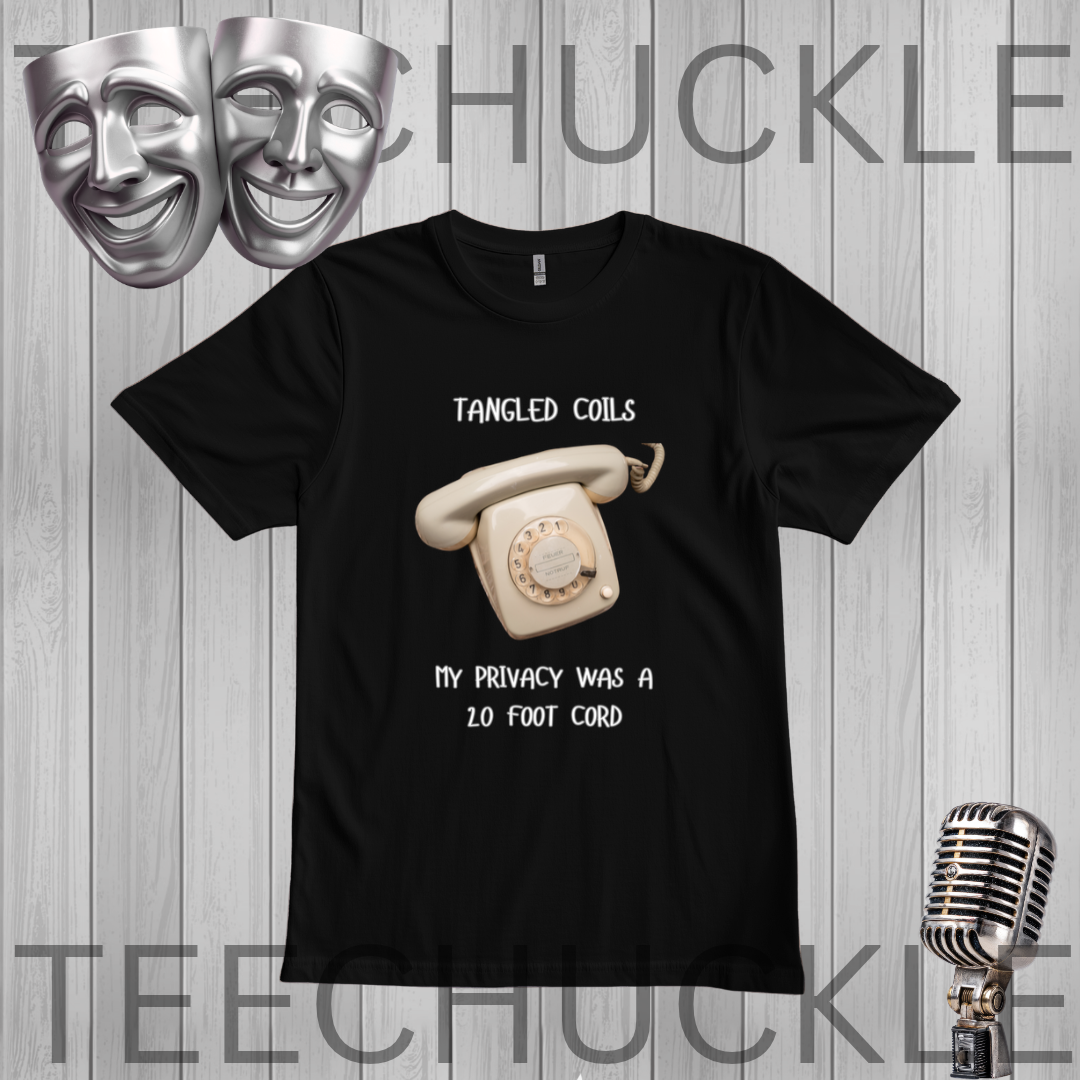 A black short-sleeve graphic t-shirt featuring a retro cream rotary phone and the text 'Tangled Coils' and 'My Privacy Was A 20 Foot Cord'. The shirt is displayed on a gray wood-plank background with a silver theater mask, a vintage microphone