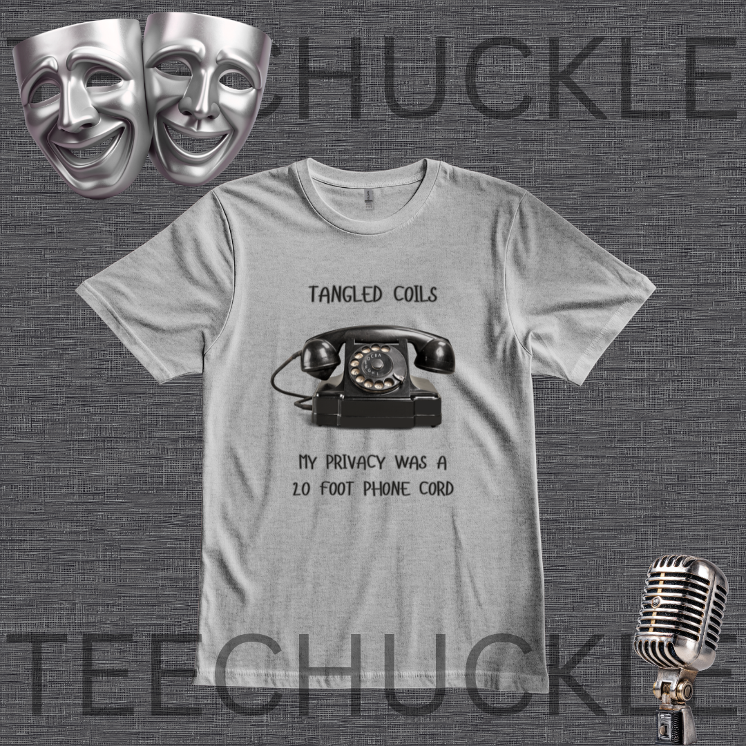 A gray graphic t-shirt featuring a black retro rotary phone and the text 'Tangled Coils' and 'My Privacy Was a 20 Foot Phone Cord'. The t-shirt is displayed on a dark gray textured background with theatrical comedy masks, a vintage microphone,