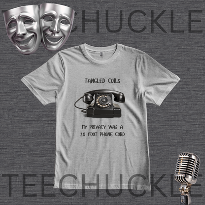 A gray graphic t-shirt featuring a black retro rotary phone and the text 'Tangled Coils' and 'My Privacy Was a 20 Foot Phone Cord'. The t-shirt is displayed on a dark gray textured background with theatrical comedy masks, a vintage microphone,