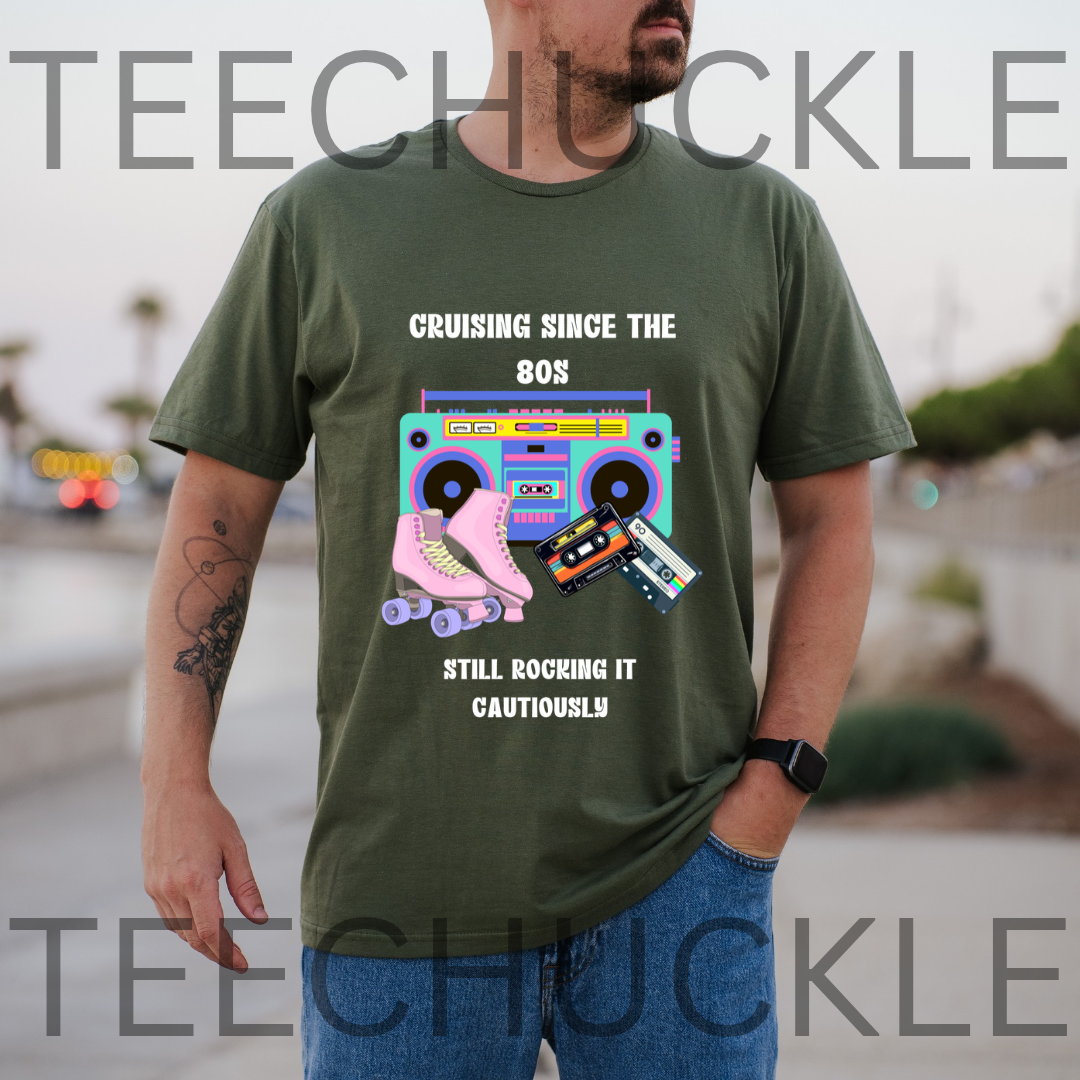 A man wearing a green graphic t-shirt with a retro 80s theme featuring a boombox, cassette tapes, and roller skates, with the text 'CRUISING SINCE THE 80S STILL ROCKING IT CAUTIOUSLY'.