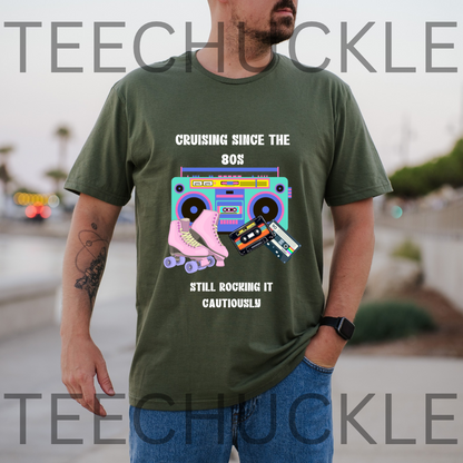 A man wearing a green graphic t-shirt with a retro 80s theme featuring a boombox, cassette tapes, and roller skates, with the text 'CRUISING SINCE THE 80S STILL ROCKING IT CAUTIOUSLY'.