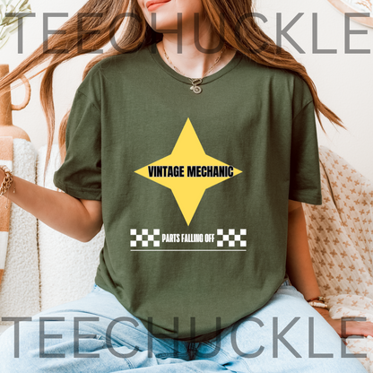 A woman wearing an oversized a green graphic t-shirt with a yellow star and 'VINTAGE MECHANIC' text, paired with light blue jeans.