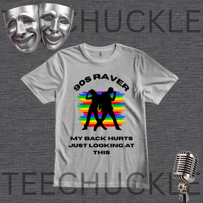 A gray graphic t-shirt displayed on a dark gray textured background. The shirt features a black graphic of two silhouetted figures in front of a rainbow-striped background, with the text '90S RAVER' above and 'MY BACK HURTS JUST LOOKING AT THIS' below.