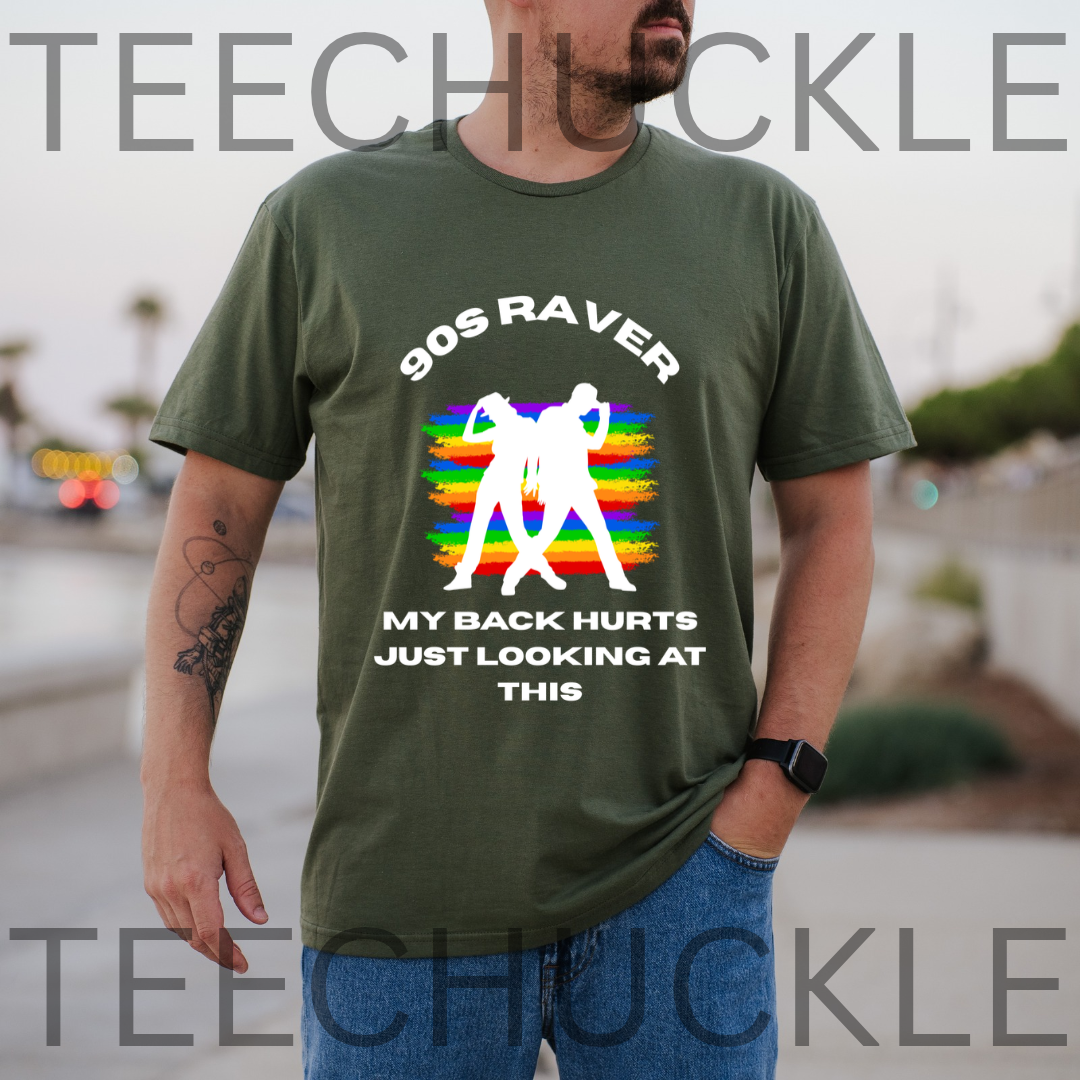 A man wearing a green graphic t-shirt with a white and rainbow design that reads '90S RAVER MY BACK HURTS JUST LOOKING AT THIS'. 