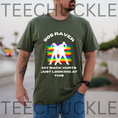 A man wearing a green graphic t-shirt with a white and rainbow design that reads '90S RAVER MY BACK HURTS JUST LOOKING AT THIS'. 