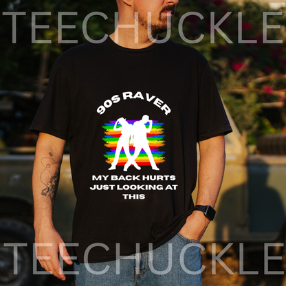 A man wearing a black graphic t-shirt with a '90s Raver' design featuring white text and a white silhouette over a rainbow-striped background. 