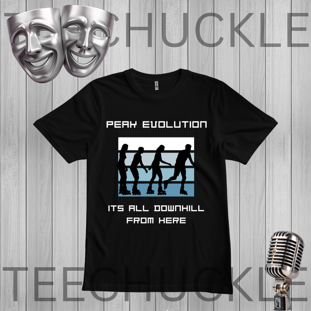 A black graphic t-shirt displayed on a gray wood plank background, featuring the text 'PEAK EVOLUTION' and 'ITS ALL DOWNHILL FROM HERE' with roller derby silhouettes. Silver theater masks and a vintage microphone are floating as decorative props