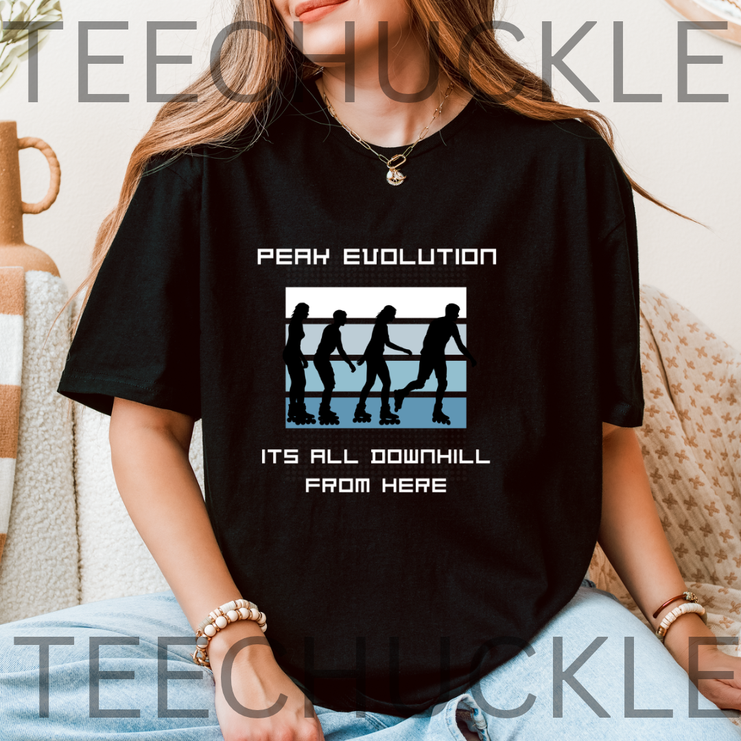 A woman wearing a black graphic t-shirt with the text 'PEAK EVOLUTION' and 'ITS ALL DOWNHILL FROM HERE' surrounding a graphic of four silhouettes on a blue and white background.