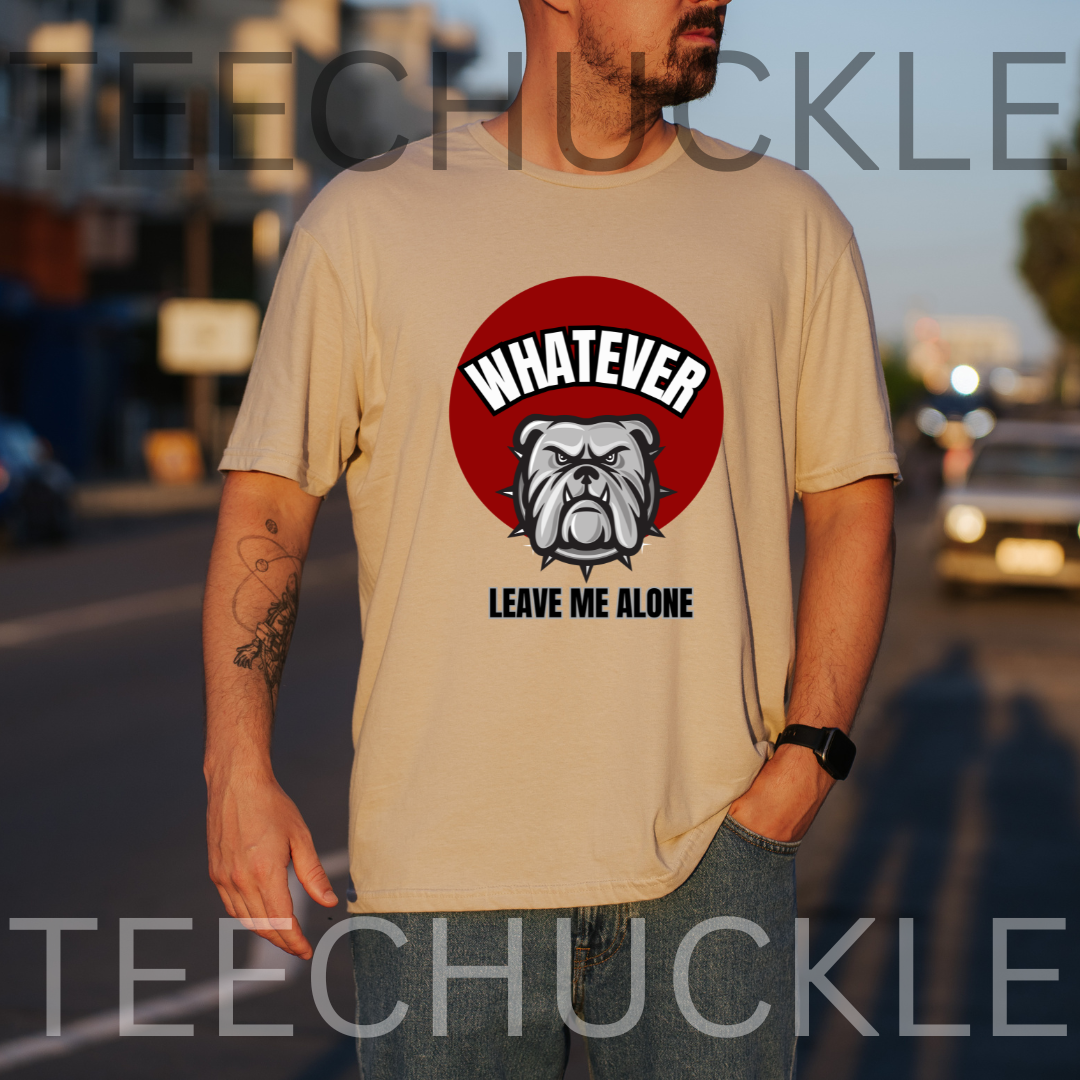 A man wearing a sand graphic t-shirt with a red circular bulldog design and the text 'WHATEVER LEAVE ME ALONE'. The photo is taken outdoors on a street at sunset