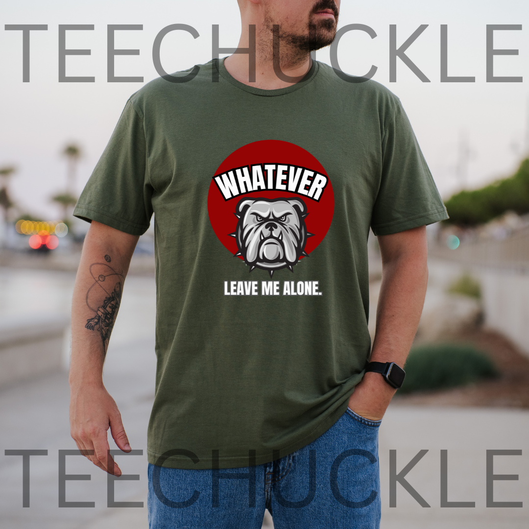 A man wearing a green graphic t-shirt with a red circular bulldog design and the text 'WHATEVER LEAVE ME ALONE.' The background is a blurred outdoor street scene,