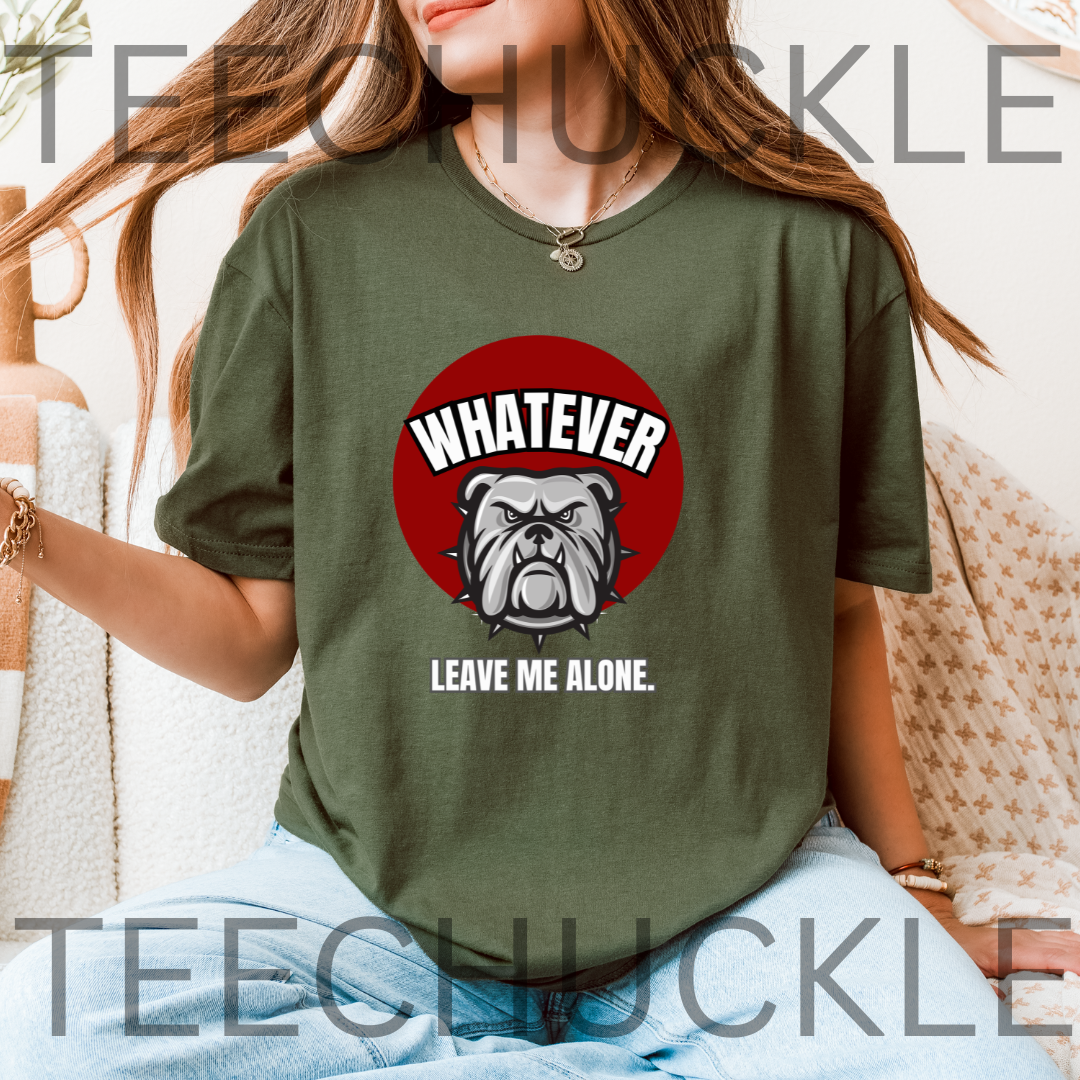 A woman wearing a green graphic t-shirt with a red circular bulldog design and the text 'WHATEVER LEAVE ME ALONE'.