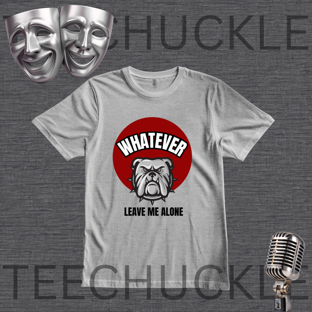 A gray graphic t-shirt displayed on a dark gray textured background, featuring a red circular graphic with a bulldog illustration and the text 'WHATEVER LEAVE ME ALONE'. The image includes decorative props like silver theater masks and a vintage microphone