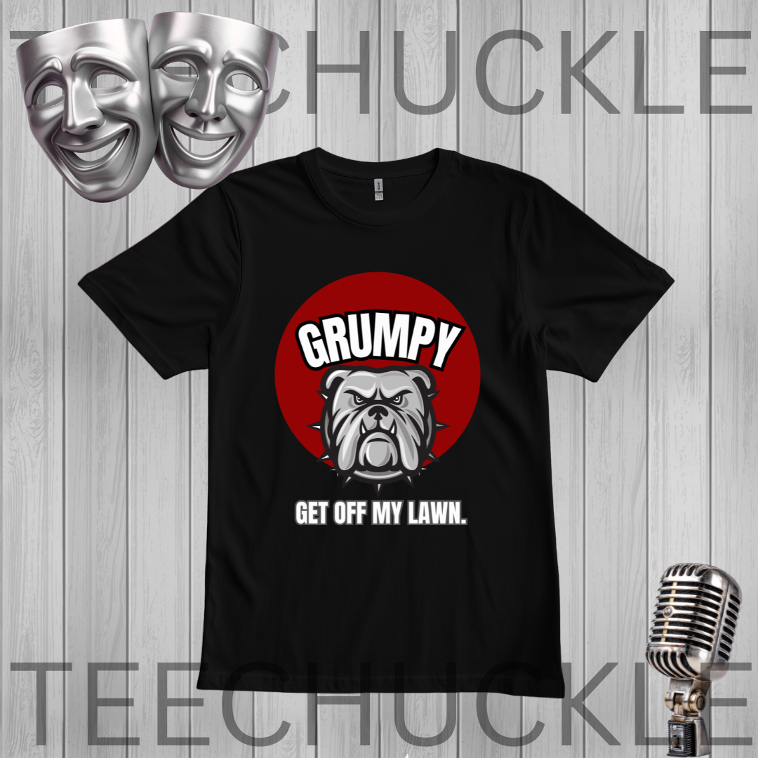 A black short-sleeve graphic t-shirt displayed on a gray wood-plank background. The shirt features a red circular graphic with a bulldog illustration and the text 'GRUMPY GET OFF MY LAWN.