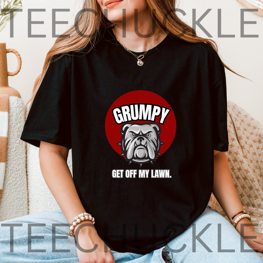 A woman wearing a black graphic t-shirt with a red circular bulldog design and the text 'GRUMPY GET OFF MY LAWN.'