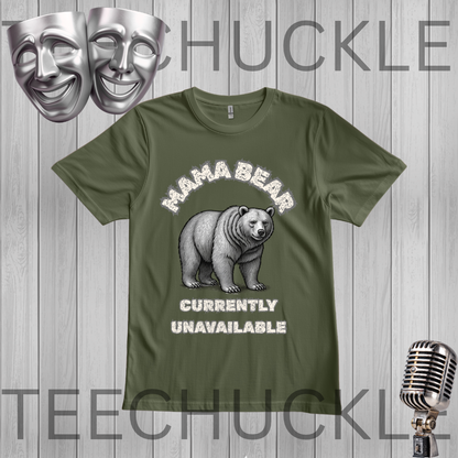 A green graphic t-shirt featuring a white and gray illustration of a grizzly bear with the text 'MAHA BEAR' above and 'CURRENTLY UNAVAILABLE' below. The t-shirt is displayed on a gray wood-plank background with decorative props including a silver microphone, theater masks