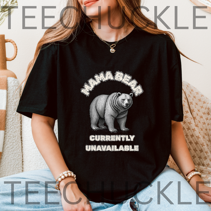 A woman wearing a black graphic t-shirt with a white distressed print of a bear and the text 'MAMA BEAR CURRENTLY UNAVAILABLE'.