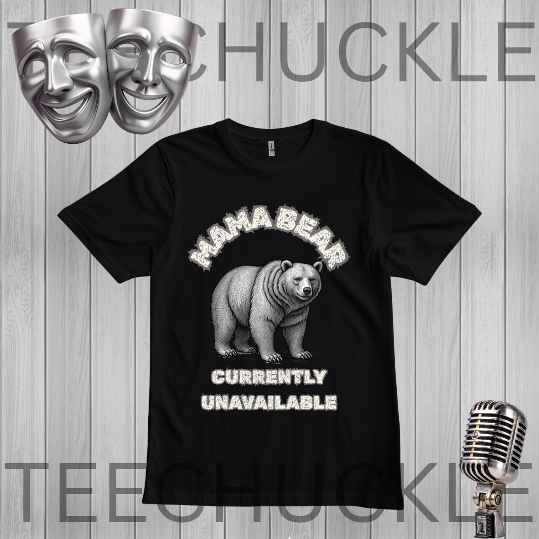 A black short-sleeve graphic t-shirt featuring a distressed white print of a grizzly bear and the text 'MAMA BEAR EXHAUSTED EDITION'. The t-shirt is displayed on a gray wood-plank background with theatrical comedy and tragedy masks, a vintage microphone, 