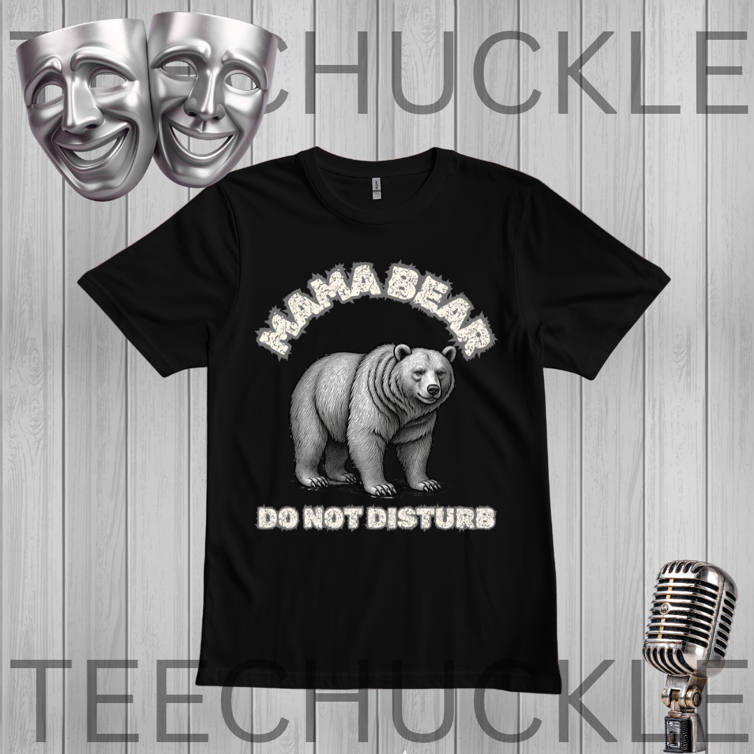 A black short-sleeve graphic t-shirt featuring a white and gray illustration of a bear with the text 'MAHA BEAR DO NOT DISTURB'. The t-shirt is displayed on a gray wood-plank background with a vintage microphone, theater masks