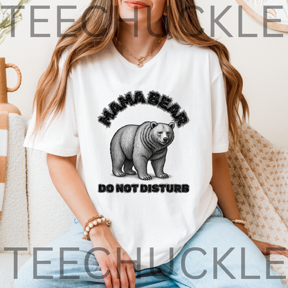 A woman wearing a white graphic t-shirt with a black and gray 'MAMA BEAR DO NOT DISTURB' design featuring a bear illustration.