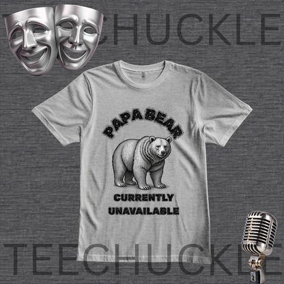 A gray graphic t-shirt featuring a black bear illustration and the text 'PAPA BEAR CURRENTLY UNAVAILABLE'. The t-shirt is displayed on a dark gray textured background with a 'TEECHUCKLE' watermark, accompanied by two silver comedy masks in the top-left and a vintage silver microphone in the bottom-right.