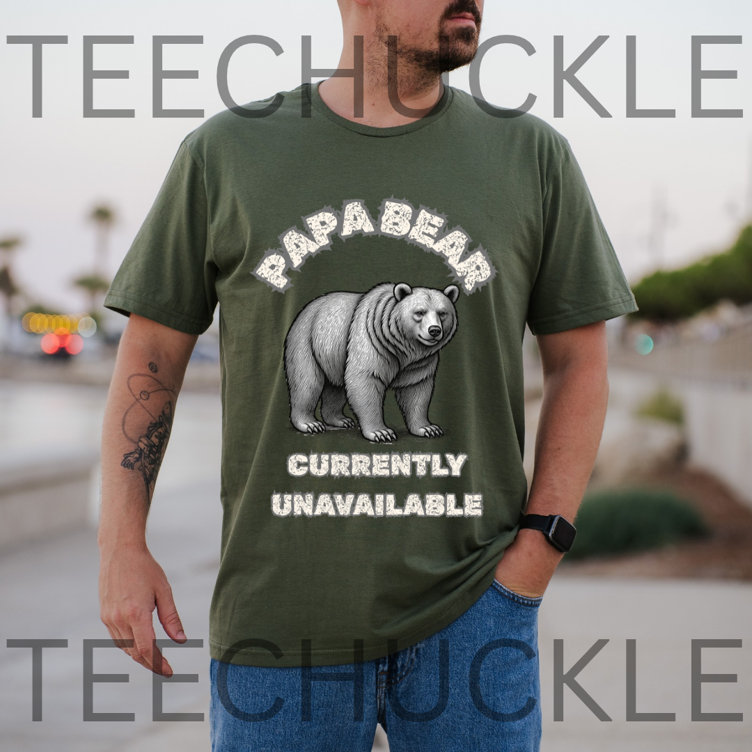 A man wearing a green graphic t-shirt with a polar bear illustration and the text 'PAPA BEAR CURRENTLY UNAVAILABLE' in a retro style. The background is a blurred outdoor street scene