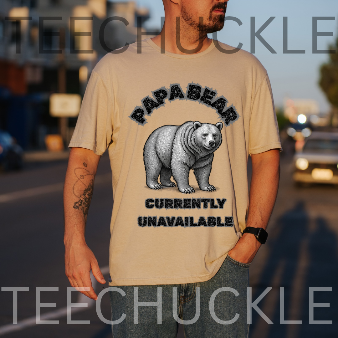 A man wearing a sand graphic t-shirt with a black and gray illustration of a polar bear and the text 'PAPABEAR CURRENTLY UNAVAILABLE'. 