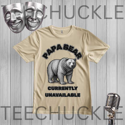 A sand graphic t-shirt featuring a polar bear illustration and the text 'PAPABEAR CURRENTLY UNAVAILABLE' in black. The t-shirt is displayed on a gray wood-plank background with decorative silver theater masks and a vintage microphone