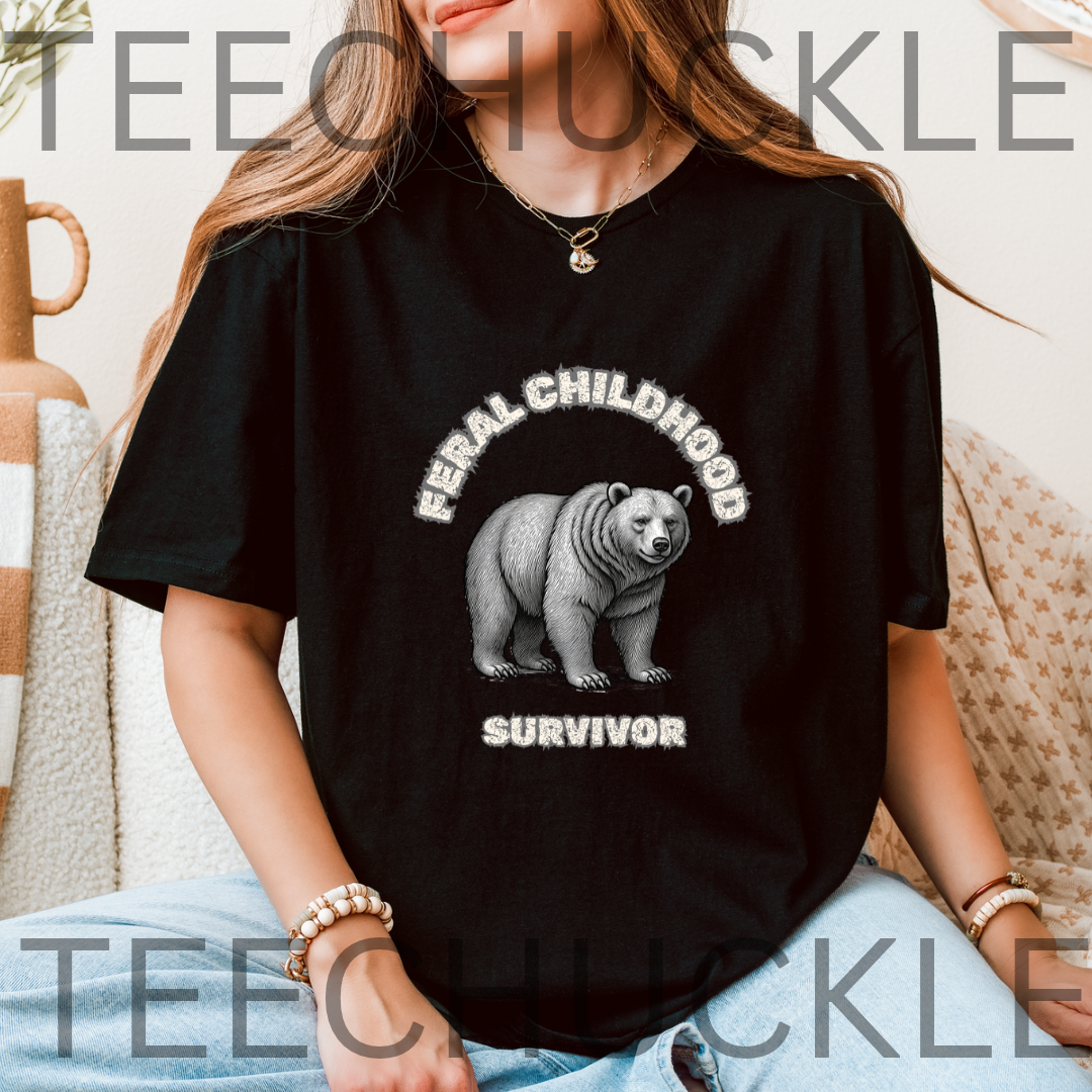 A woman wearing a black graphic t-shirt with a white printed design of a polar bear and the words 'FERAL CHILDHOOD SURVIVOR'.