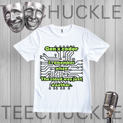A white short-sleeve graphic T-shirt laid flat on a gray wood-plank background. The shirt has a printed design with green text reading 'Gen x coder I remember when The cloud was just weather.