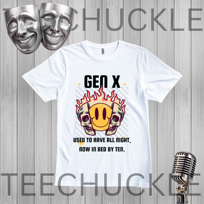 A white graphic t-shirt displayed on a gray wood-plank background, featuring a 'Gen X' meme design with two skulls, a yellow smiley face in flames, and text about being used to rave all night, now in bed by tea. The image includes decorative silver theater masks in the top left and a vintage microphone in the bottom right