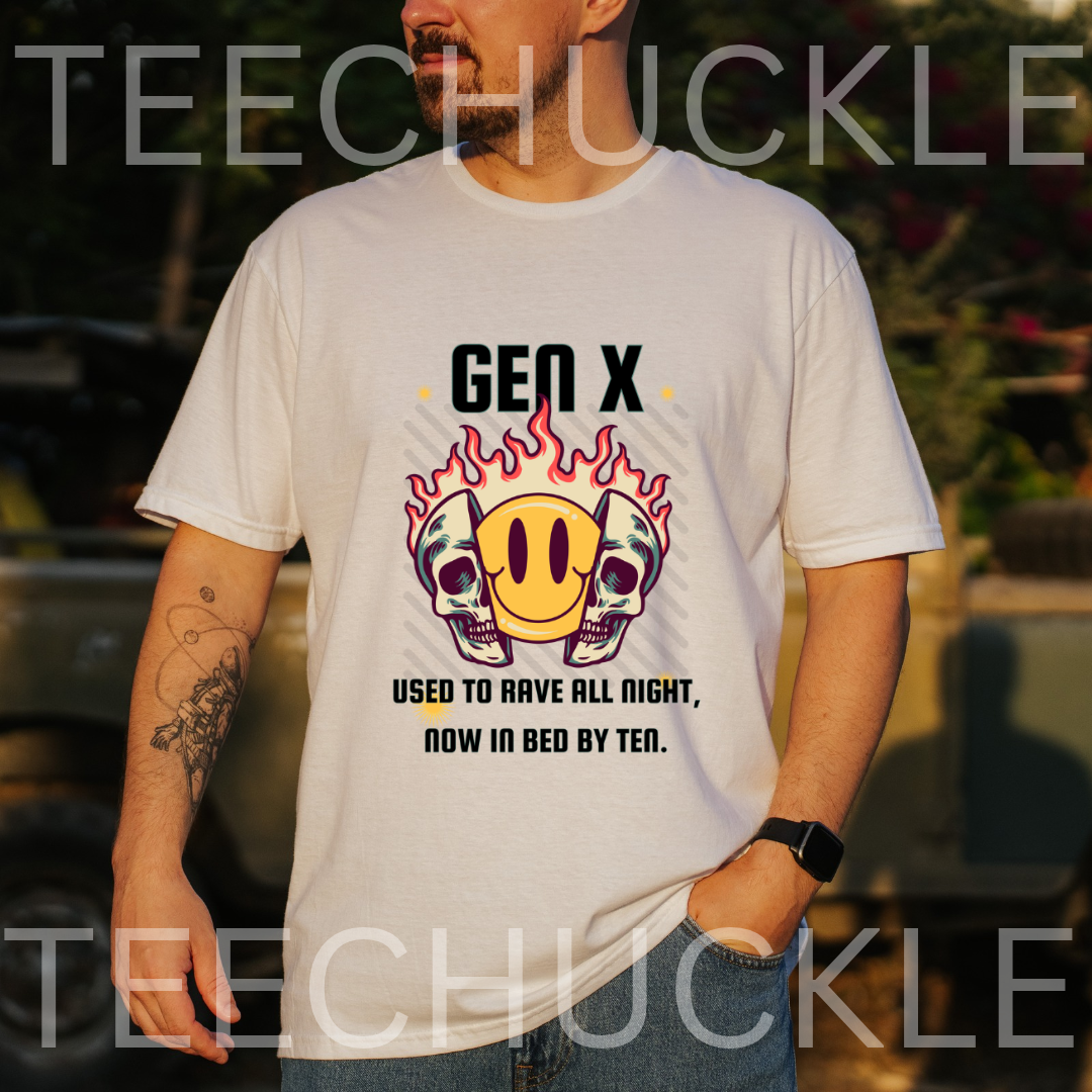 A man wearing a white graphic t-shirt with a 'Gen X' emoji skull design, standing outdoors with a blurred background. The t-shirt features a yellow smiley face between two skulls with flames, and text that reads 'GEN X USED TO RAVE ALL NIGHT, NOW IN BED BY TEN.