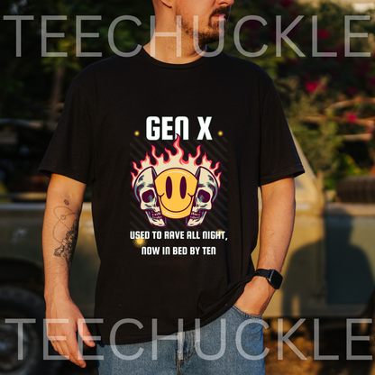 A man wearing a black graphic t-shirt with a 'Gen X' design featuring skulls, a smiley face, and flames. The background is an outdoor blurred setting with a vintage car,