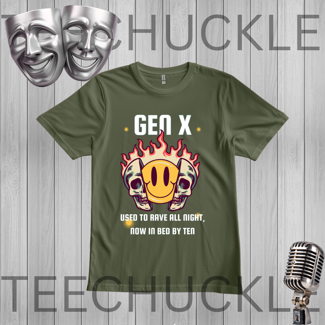 A green graphic t-shirt displayed on a gray wood plank background, featuring a 'Gen X' theme with a flame skull and smiley face graphic. The image includes decorative silver theater masks in the top left and a vintage microphone in the bottom right