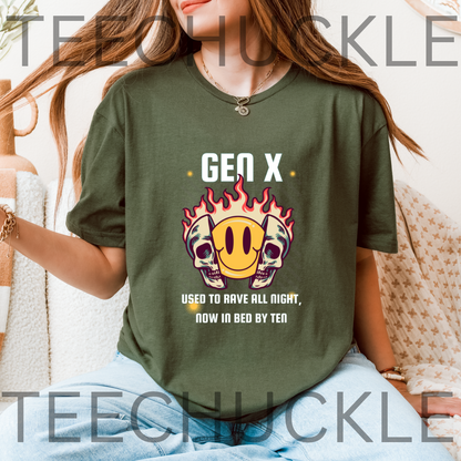 A woman wearing a green graphic t-shirt with a 'Gen X' skull and smiley face design, sitting in a cozy indoor setting. The t-shirt features the text 'GEN X USED TO RAVE ALL NIGHT, NOW IN BED BY TEAR' below the graphic.
