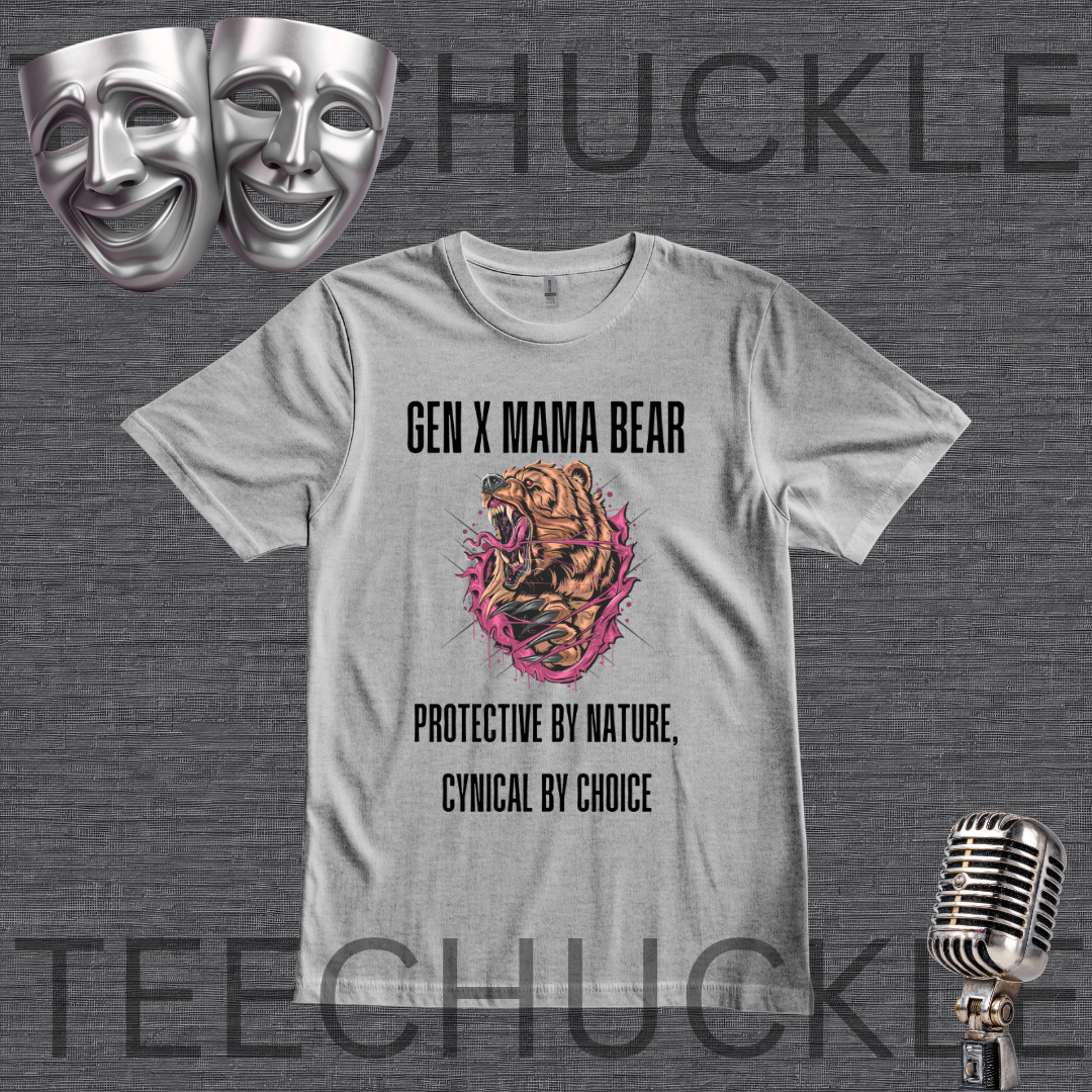 A gray graphic t-shirt displayed on a dark gray textured background, featuring a 'Gen X Mama Bear' design with a roaring bear illustration and text. The image includes decorative props like two silver theater masks in the top-left and a vintage silver microphone in the bottom-right