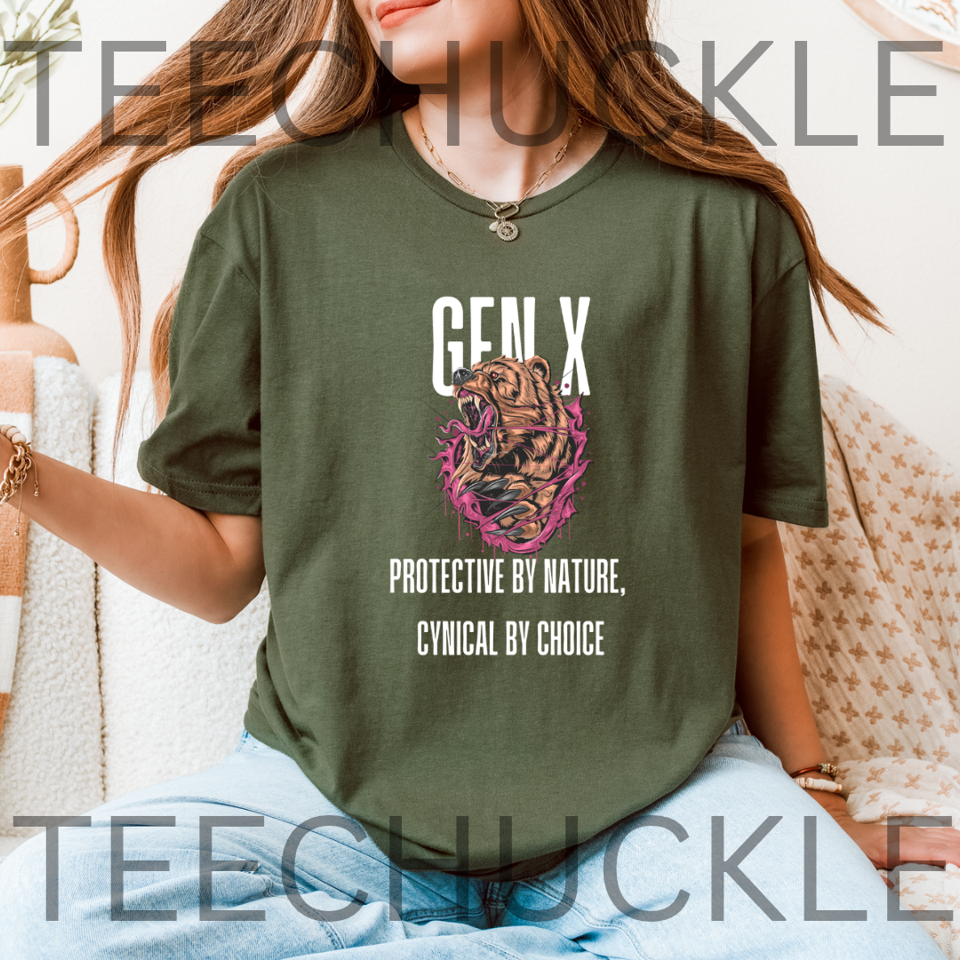 A green graphic t-shirt featuring a roaring bear illustration with pink and black details, accompanied by the text 'GEN X' and 'PROTECTIVE BY NATURE, CYNICAL BY CHOICE'.