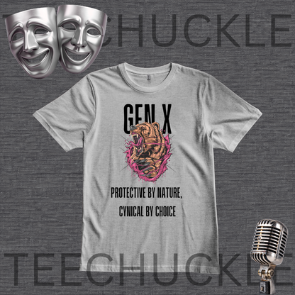 A gray graphic t-shirt featuring a roaring tiger illustration with pink and orange accents, and the text 'GEN X' and 'PROTECTIVE BY NATURE, CYNICAL BY CHOICE'. The t-shirt is displayed on a dark gray textured background with decorative props including two silver theater masks, a vintage microphone